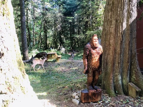 Our sasquatch, Harry, being visited by some neighborhood deer. 