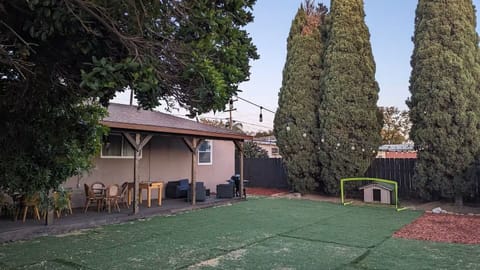 Backyard with deck, grill, roof and patio furniture!