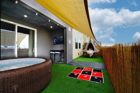 Massive private balcony with a bbq grill, outdoor TV, hot tub, shade, outdoor seating and hammock