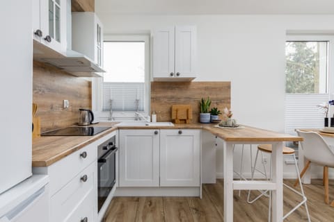 The sleek design of the kitchenette blending seamlessly with the living area.