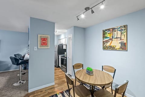 4-seater dining table with decorative paintings by the wall