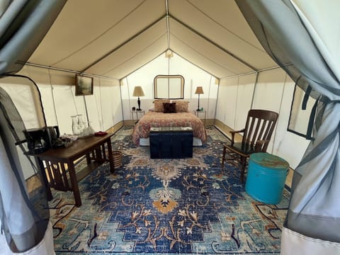 Zinnia Glamping Tent is spacious, beautiful, and cozy with a queen sized bed.