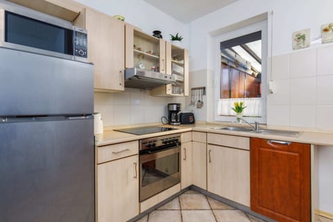 Another view of the kitchen, highlighting the stove, counter space, and practical layout.
