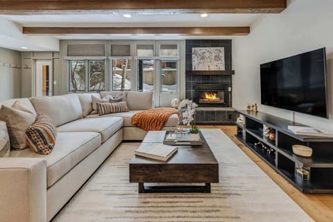 Spacious living room with large comfortable sofa, gas fireplace and Smart TV with streaming services and Xfinity cable