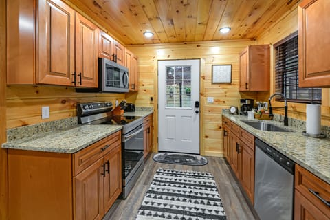 Full kitchen w/ granite counter tops and stainless-steel appliances.