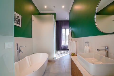 Deluxe Room, 1 King Bed | Bathroom | Separate tub and shower, deep soaking tub, hydromassage showerhead