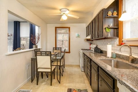 A large galley style kitchen with granite countertops and full table. Fully stocked with all appliances and cooking supplies