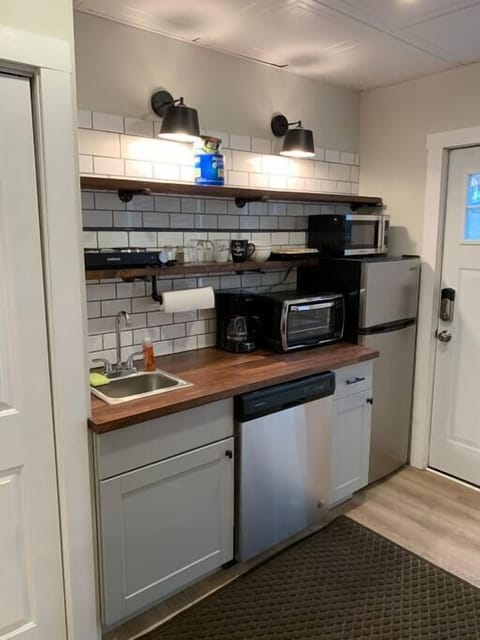 Fully stocked kitchennette with a dishwasher, two burner electric cook top, as well as toaster oven and microwave.  