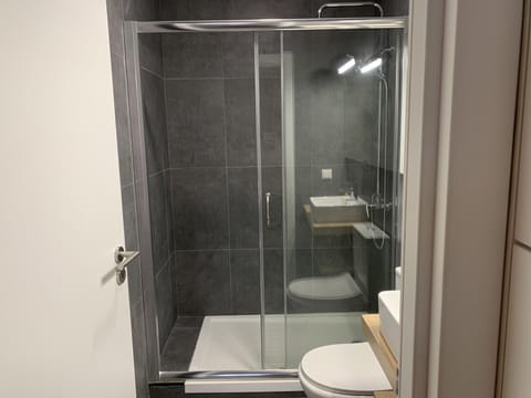 Economy Single Room, 1 Twin Bed | Bathroom | Shower, rainfall showerhead, hair dryer, towels