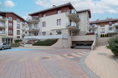 A clean and stylish apartment block with neatly maintained surroundings.