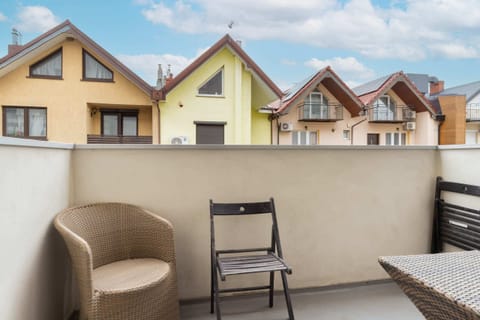 A balcony with a seating area, offering a peaceful outdoor space for relaxation.
