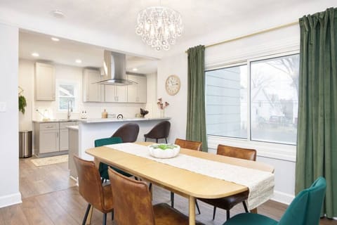 This open-concept dining area flows into a modern kitchen with bar seating—perfect for shared meals, morning coffee, or evening wine with friends.