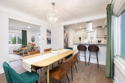 This open-concept dining area flows into a modern kitchen with bar seating—perfect for shared meals, morning coffee, or evening wine with friends.