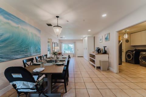 Dining area set for 6, with a high chair and child-friendly plates, cups, spones