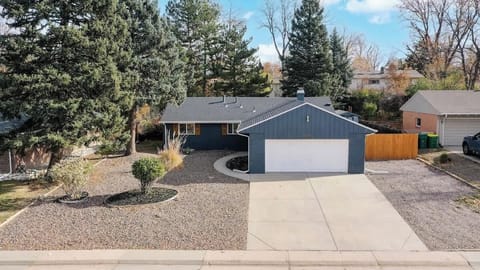 A beautifully maintained home with a spacious driveway, modern blue exterior, and a well-landscaped front yard—offering great curb appeal!