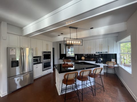 large kitchen with stove, double oven, and keurig