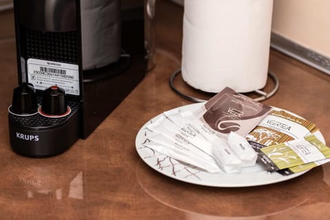 A close-up of the kitchen counter, showing a coffee machine and other essentials.