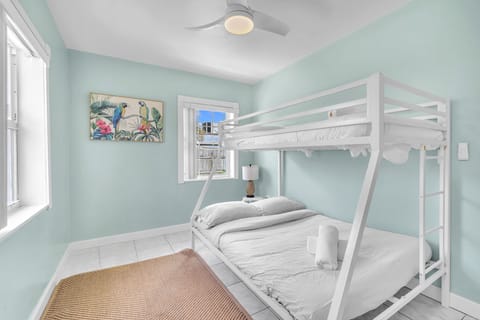 Guest bedroom has a decently sized bunk bed with plush pillows and comfy sheets.