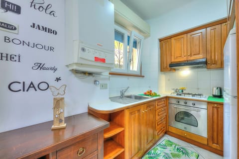 Family Apartment, 2 Bedrooms (Leonardo House Garden Stresa Center) | Private kitchen | Fridge, microwave, oven, stovetop