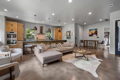 Open living room and kitchen with smart TV and appliances