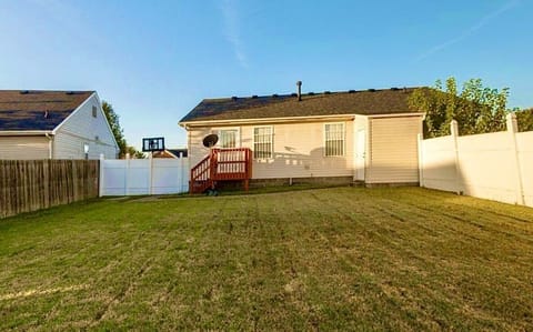 LARGE FENCED BACKYARD WITH A DECK.