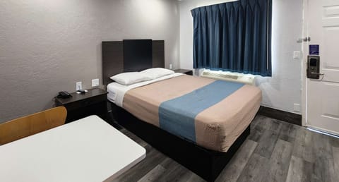 Deluxe Room, 1 Queen Bed, Non Smoking, Kitchenette | Desk, laptop workspace, blackout drapes, iron/ironing board