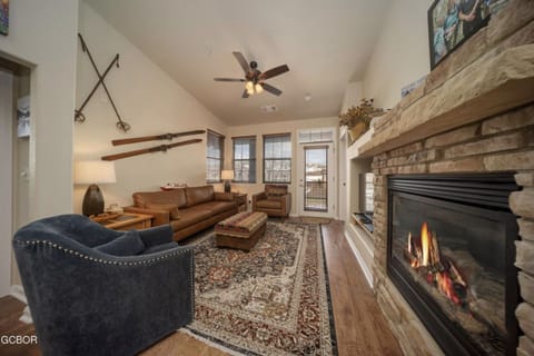 The living room has a warm fireplace and beautiful mountain views.