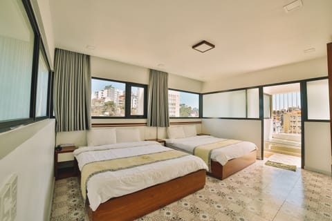 Deluxe Quadruple Room | Premium bedding, down comforters, memory foam beds, desk