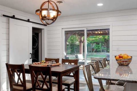 Gather for meals and board games at our light‑filled dining table, just steps from the gourmet kitchen.