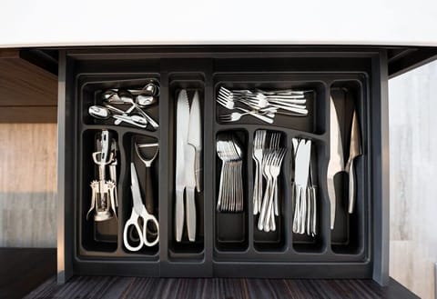 Fully stocked with sleek cutlery and utensils for your culinary needs.