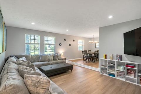 Large sunken living room with tons of space and seating! 75 inch TV