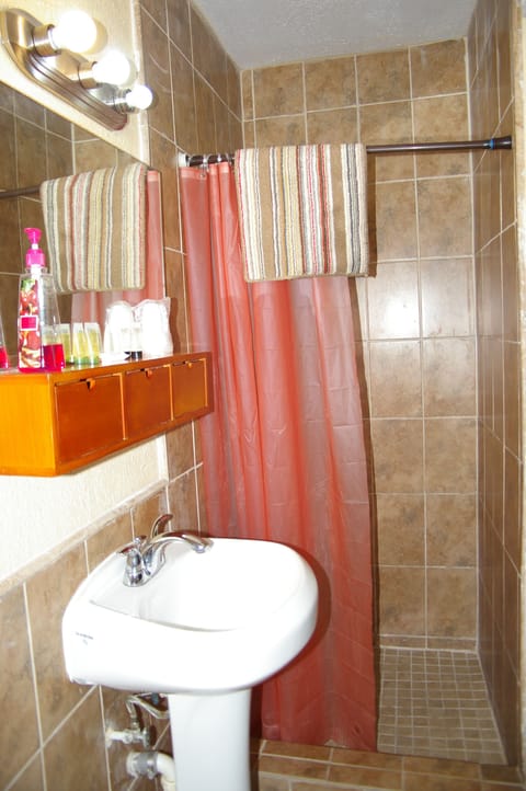 Standard Room, 1 King Bed, Refrigerator & Microwave | Bathroom | Shower, designer toiletries, towels, soap