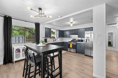 Spacious kitchen and dining area with an integrated workspace, ideal for meal prep, dining, and productivity. The functional layout includes ample counter space, modern appliances, and a cozy dining nook, while the workspace offers a convenient spot