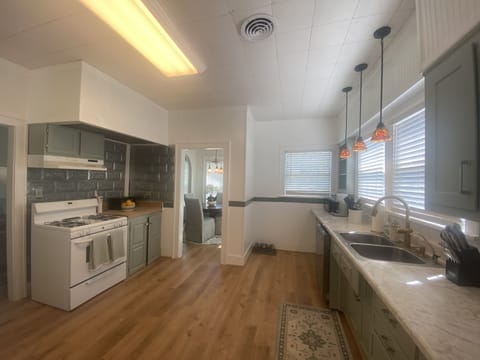 Spacious kitchen with oven, dishwasher, refrigerator, microwave, coffee machine