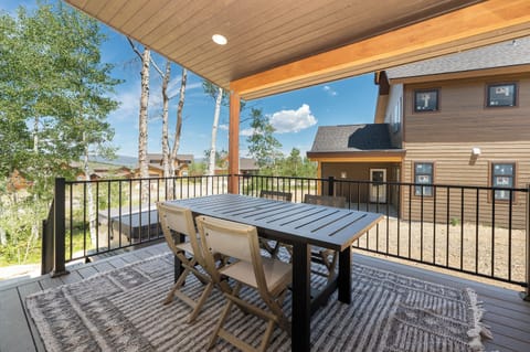 Deck area off of main level with seating, grill, and hot tub!