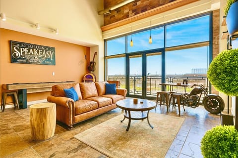 Enjoy our welcoming living room, where a plush leather couch and chairs await your comfort. Dominating the space is a magnificent 75-inch HD TV, ready to elevate your vacation relaxation with endless entertainment options. 