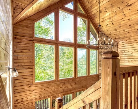 Cathedral ceilings and oversized windows allow an abundance of natural light to cascade into the cabin.