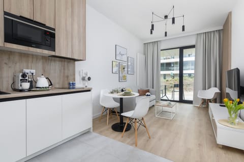 Another perspective of the living room, showing the open-plan layout leading to the dining and kitchen area.