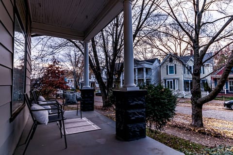 Covered front porch and view of neighboring homes.