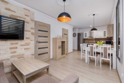 A similar perspective of the living room showcasing the open layout and dining area in the background.