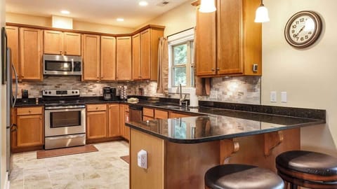 The roomy kitchen features granite countertops and stainless steel appliances and, as you can see, is not short on cabinet space.