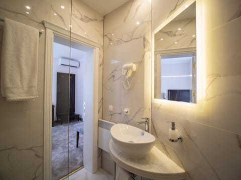 Luxurious Single Room | Bathroom | Shower, designer toiletries, hair dryer, slippers