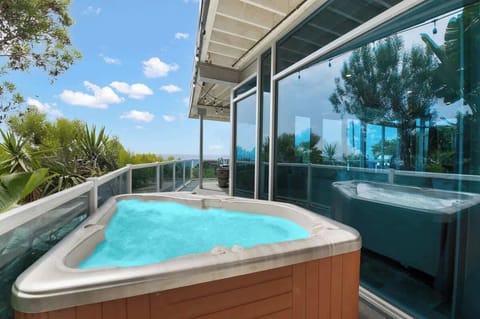 Take your relaxation to new heights with a hot tub on the balcony, overlooking the ocean and surrounded by vibrant greenery. A peaceful haven where every moment feels like a mini escape.
