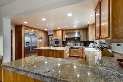 The spacious chef’s kitchen features sleek granite countertops.
