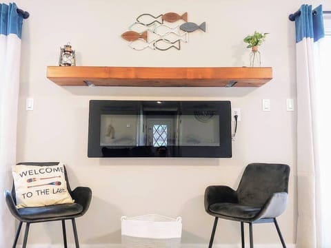 Electric fireplace in the 4-bedroom home. Please watch the kiddos!