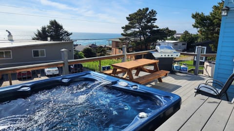 6 person hot tub with ocean view, BBQ, chairs and 6 person table