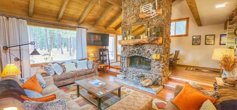 Double sided wood burning fireplace, 3 full size couches with a 55" HD TV