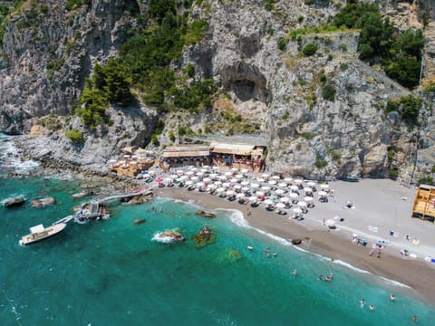 On the beach, black sand, beach umbrellas, beach towels