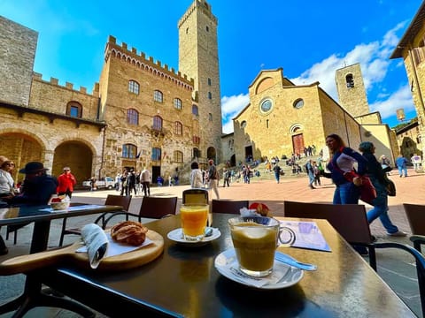 Enjoying breakfast on the Piazza a short walk from our place