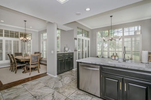 Kitchen with lots of natural light and large floor to ceiling windows providing an unobstructed view of the golf course.